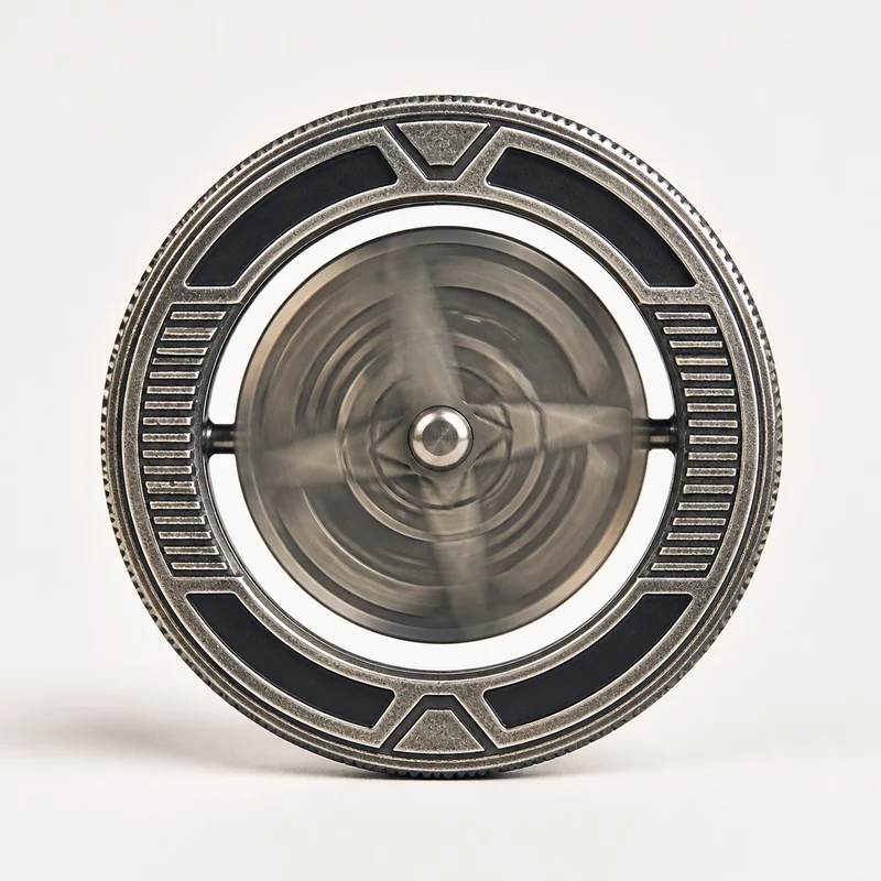 Spinner coin with rotating center mounted inside an outer ring